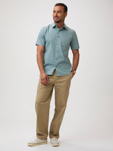 Man wearing a light blue-green button up shirt and khaki pants | stretch cotton-poly-spandex blend for all-day ease and mobility