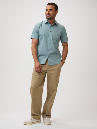 Man wearing a light blue-green button up shirt and khaki pants | stretch cotton-poly-spandex blend for all-day ease and mobility