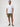 Man wearing a white short-sleeve shirt and green shorts | breathable button up shirts