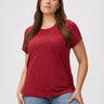 Laurel is 5'7" and wears a size M # Chili Red Classic crew neck, elevated fit & feel | Woman wearing a red t-shirt with denim jeans