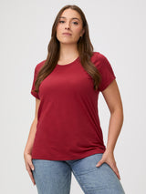 Laurel is 5'7" and wears a size M # Chili Red Classic crew neck, elevated fit & feel | Woman wearing a red t-shirt with denim jeans