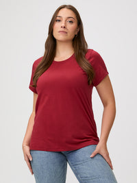 Laurel is 5'7" and wears a size M # Chili Red Classic crew neck, elevated fit & feel | Woman wearing a red t-shirt with denim jeans