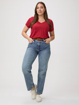 Style Versatility # Woman wearing a chili red t-shirt and blue jeans with brown belt