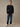 A man wearing a black long-sleeve flannel shirt, dark blue jeans, and white sneakers. 280 GSM waffle knit traps warmth without overheating