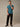 Man wearing casual teal polo shirt, with a structured collar that holds wash after wash