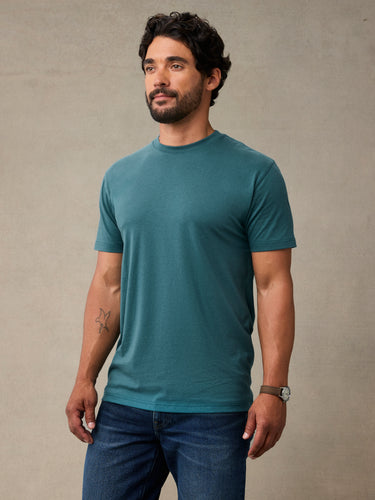 Man wearing teal blue crew neck t-shirt made from StratuSoft™ cotton poly blend