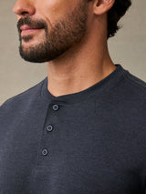 Close-up of breathable cotton poly fabric on charcoal henley placket