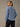 A woman shown from the back wearing a Skyline blue long-sleeve cozy thermal and dark jeans. Soft 280 GSM waffle knit fabric.
