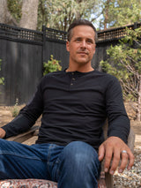 Ben is 6'1, 180lbs and wears a size M # Black Slim Fit Long Sleeve Henley Lifestyle Size Medium | Fresh Clean Threads