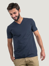 Pasha is 6' 180 lbs and wears a size M # Odyssey Blue V-Neck Size Medium in Studio | Fresh Clean Threads