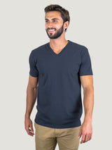 Pasha is 6' 180 lbs and wears a size M # Odyssey Blue V-Neck Size Medium in Studio | Fresh Clean Threads