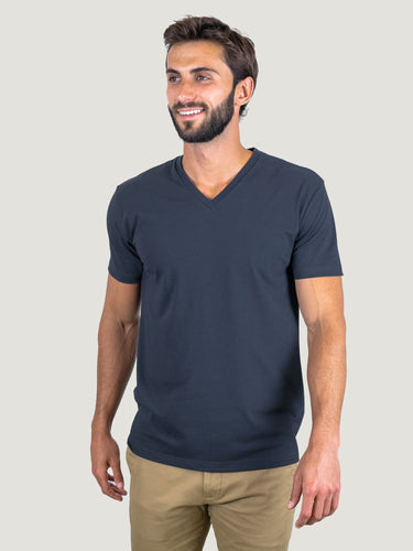 Pasha is 6' 180 lbs and wears a size M # Odyssey Blue V-Neck Size Medium in Studio | Fresh Clean Threads
